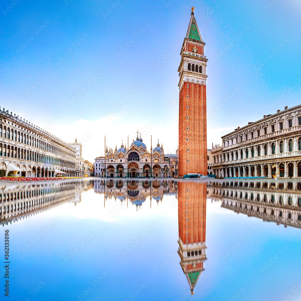 Sunrise in San Marco square with Campanile and San Marco's Basilica. Panorama of the main square of the Old town. Venice, Veneto, Italy. Reflection on the flooded square.