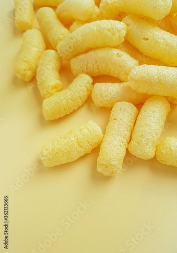 Yellow corn sticks on a yellow background.
