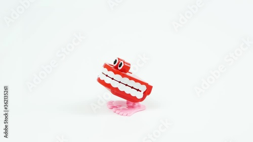 Chattering teeth toy stops in the middle, white background photo