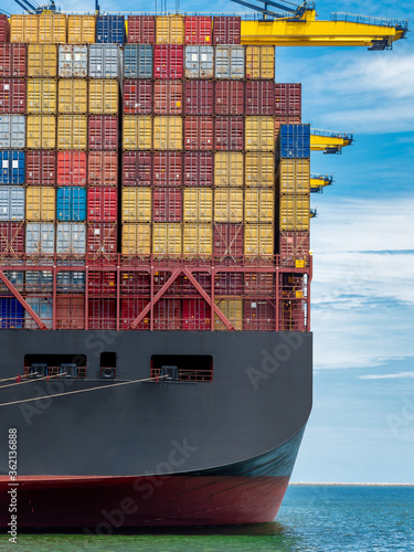 The big container vessel alongside at the port and during discharge containers to yard.