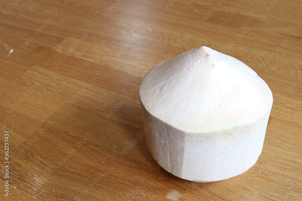 Peeled coconut on wooden table Peeled coconut on wooden table