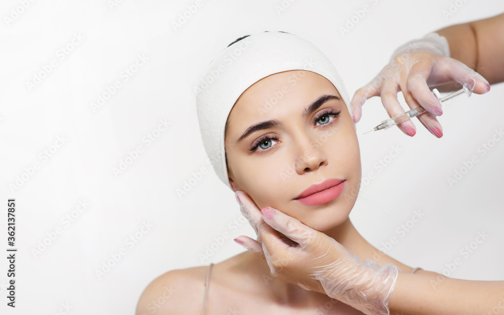 Cosmetology treatment in a clinic or beauty salon. Close-up face injection for a young woman. Beautician at work. The concept of perfect smooth clean skin and eternal youth Cosmetology treatment in a clinic or beauty salon. Close-up face injection for a young woman. Beautician at work. The concept of perfect smooth clean skin and eternal youth