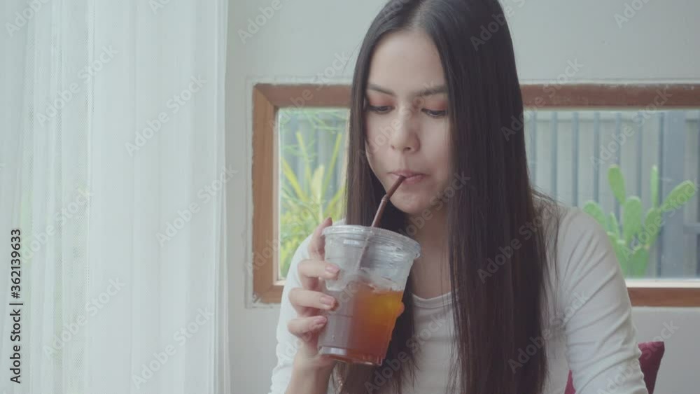 a young attractive woman is enjoying with coffee in coffee shop a young attractive woman is enjoying with coffee in coffee shop