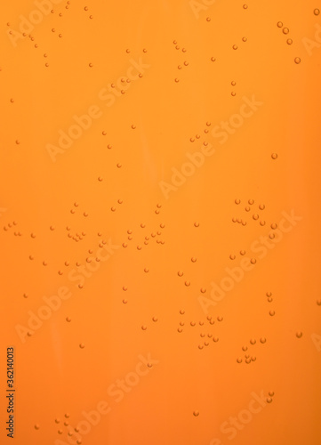 Small bubbles in orange juice. Background pattern.