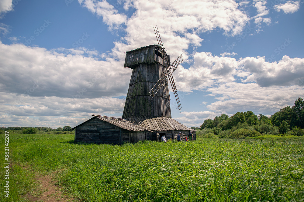 View of a wooden windmill in the Russian village in summer