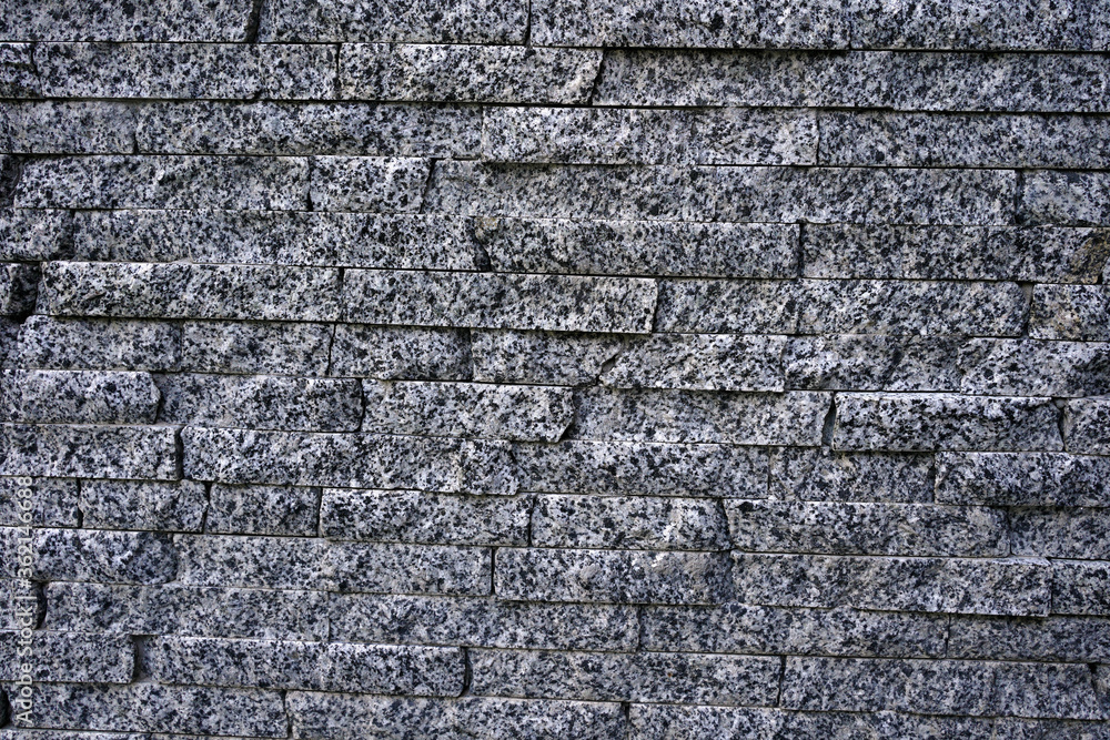 wall from natural granite in the form of a brick