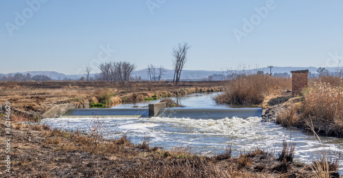 The Klip River runs through a dry winter Gauteng Highveld landscape in South Africa image in horizontal format