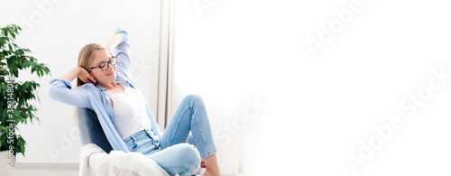 фотографія Young woman relaxing under air conditioner at home