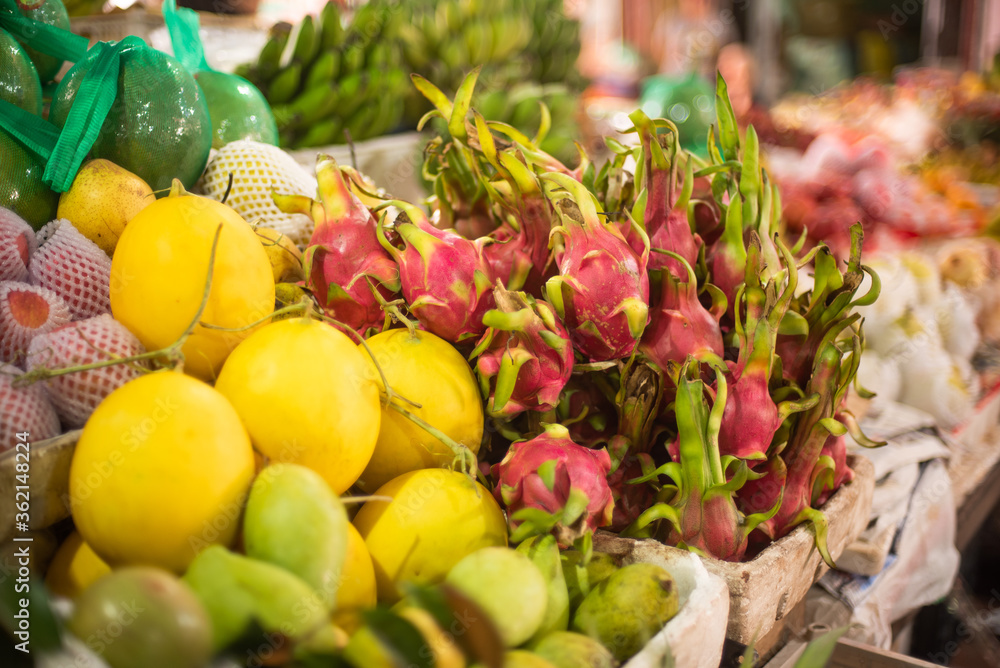 fruits, flowers and fish for sale at a market