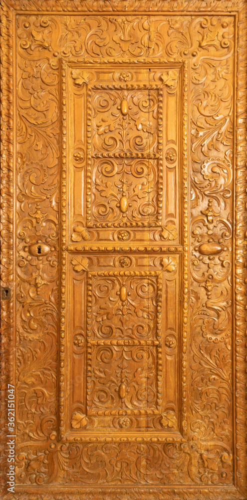 BARCELONA, SPAIN - MARCH 3, 2020: The carved door in the chruch Iglesia de Belen.