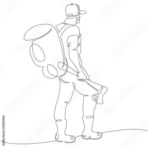 bearded man tourist in a baseball cap with a backpack and an ax