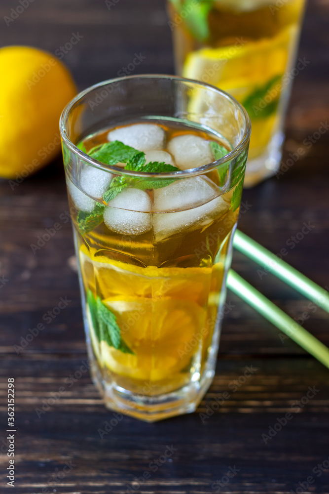 Cold tea with lemon and mint. A summer drink. Healthy eating. Vegetarian food. Diet. Cold tea with lemon and mint. A summer drink. Healthy eating. Vegetarian food. Diet.