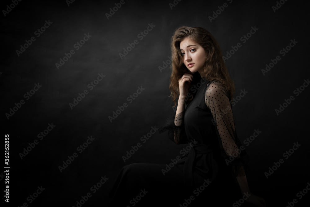 Studio portrait of a beautiful girl on a black background Studio portrait of a beautiful girl on a black background