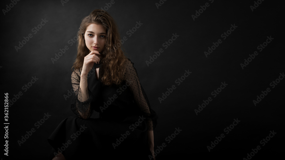 Studio portrait of a beautiful girl on a black background Studio portrait of a beautiful girl on a black background