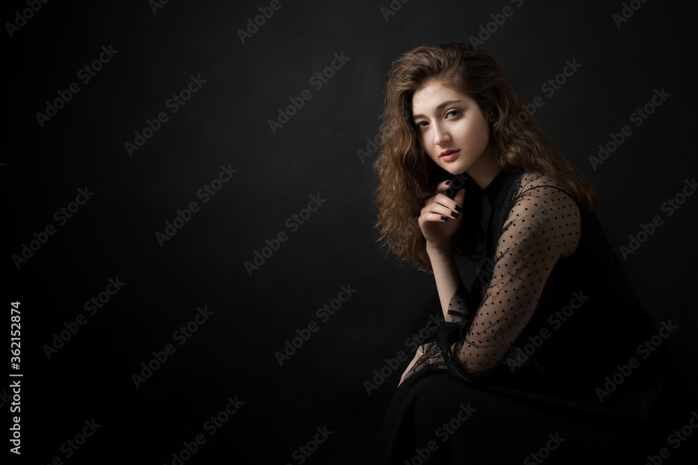 Studio portrait of a beautiful girl on a black background Studio portrait of a beautiful girl on a black background