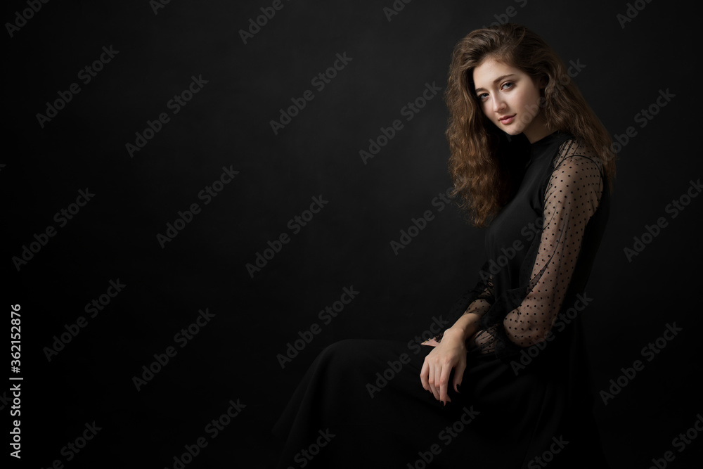 Studio portrait of a beautiful girl on a black background Studio portrait of a beautiful girl on a black background