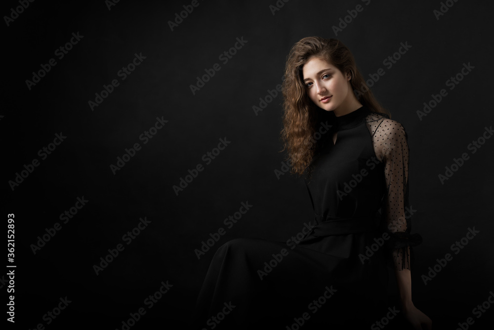 Studio portrait of a beautiful girl on a black background Studio portrait of a beautiful girl on a black background