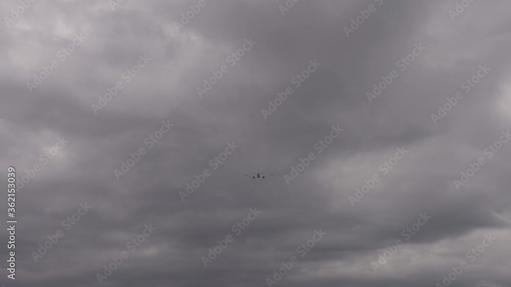 Plane flying over head on grey sky. Airplane takeoff into the sky. Plane flying over head on grey sky. Airplane takeoff into the sky.