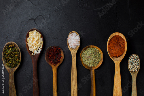 Set of wooden spoons with dry herbs and spices