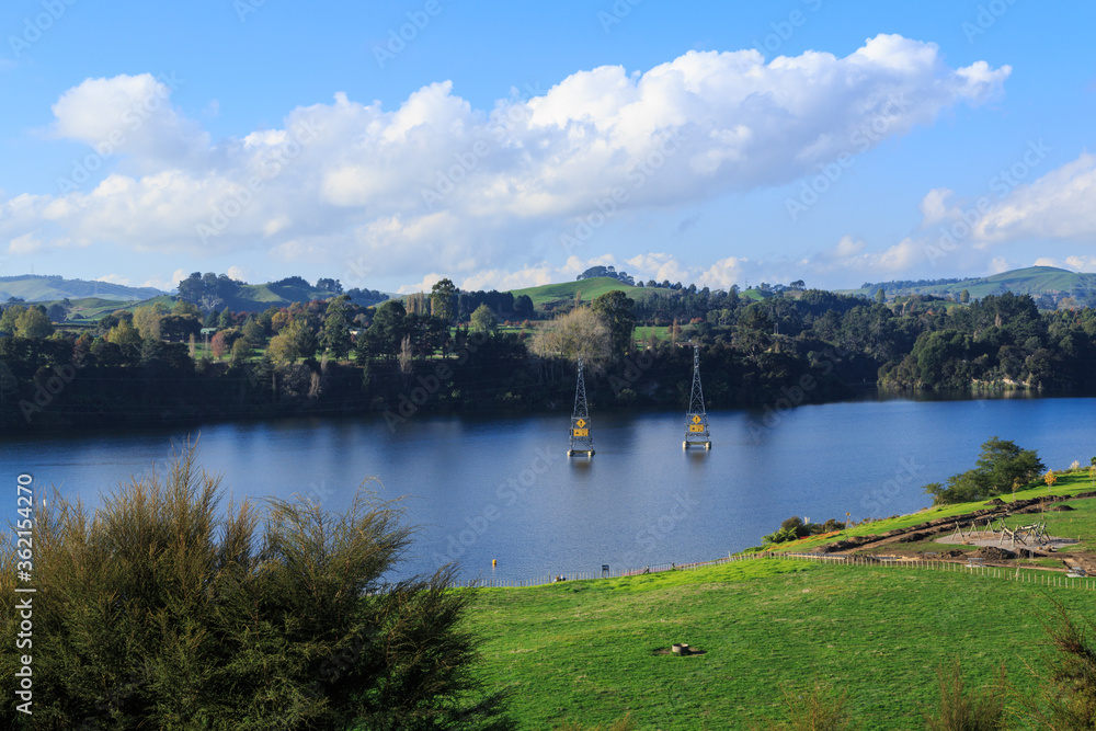 Lake Karapiro, a man-made lake in the Waikato Region, New Zealand. The power pylons carry electricity from the lake's dam