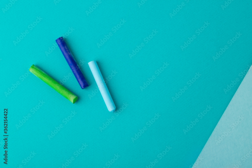pastel crayons on blue background. top view. copy space. school concept pastel crayons on blue background. top view. copy space. school concept