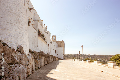 Old town of Ostuni during a sunny day, the white village. It is a turistic destination in Puglia ( apulia) in the summer. The city is in white stone bricks and is very old ( medieval time).