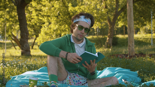 Fotografie Humorous portrait of a funny freak man reading a book