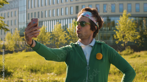 Funny freak man looking at himself in smart phone