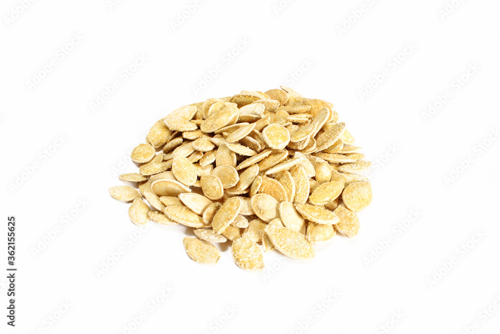 Group of salty pumpkin seeds in shell isolated on white surface. Snack food ready to eat Group of salty pumpkin seeds in shell isolated on white surface. Snack food ready to eat