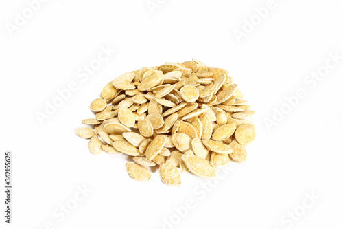 Group of salty pumpkin seeds in shell isolated on white surface. Snack food ready to eat