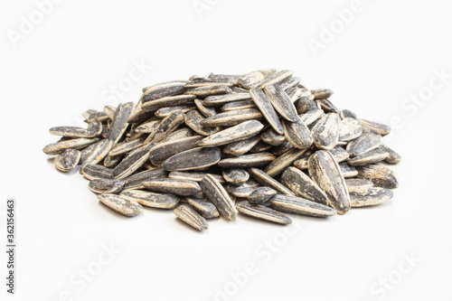 Salted and roasted sunflower seeds in shell isolated on white background