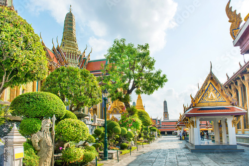 Inner court of Temple of Emerald Buddha with ornate buildings and trees. Grand Palace complex, Bangkok, Thailand © Pavlo Vakhrushev