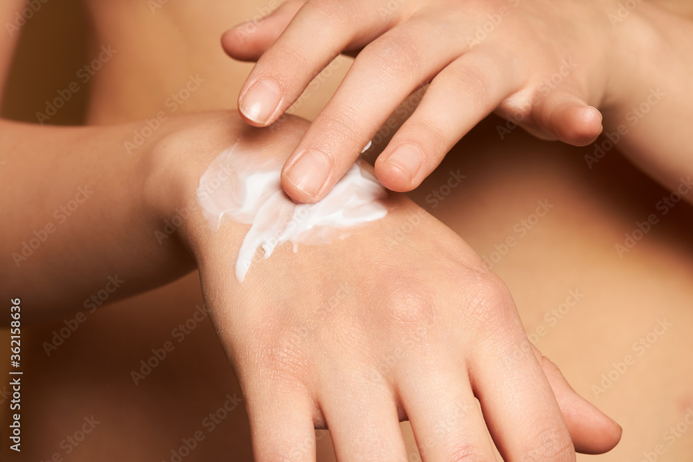 Naklejka premium Woman Hands With Cream. Closeup Of Female Hands Applying Lotion