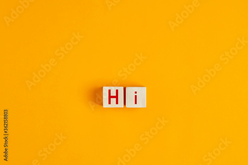 The word hi on wooden blocks. Greeting and welcoming in hospitality business concept.