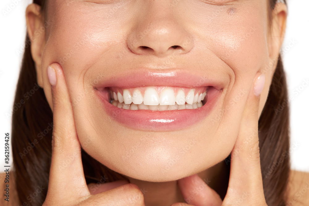Closeup of a beautiful smile with white teeth. Woman mouth smiling. High resolution image Closeup of a beautiful smile with white teeth. Woman mouth smiling. High resolution image