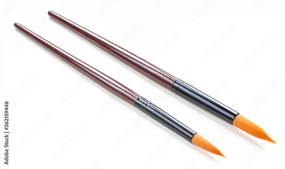 Two paint brushes of different size isolated on white background. Clean,new,dry Two paint brushes of different size isolated on white background. Clean,new,dry
