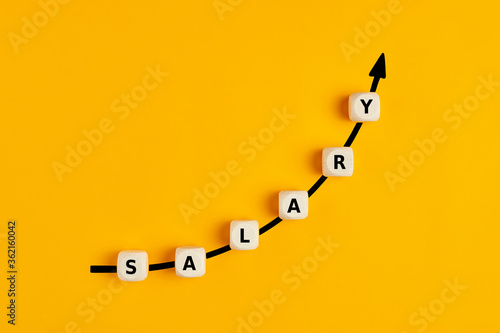 Salary raise or wage increase concept with the word salary written on wooden blocks photo