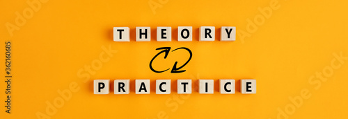 Concept of theory and practice relationship or connection. Wooden blocks with the words theory and practice. photo