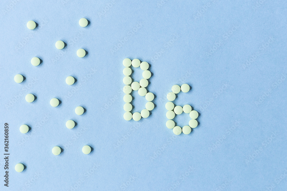 Vitamin B6 pills forming the word B6 over turquoise background, banner. free space. space for text. copy space. soft focus, blurry background. nutritional supplements, healthy food, health maintenance Vitamin B6 pills forming the word B6 over turquoise background, banner. free space. space for text. copy space. soft focus, blurry background. nutritional supplements, healthy food, health maintenance