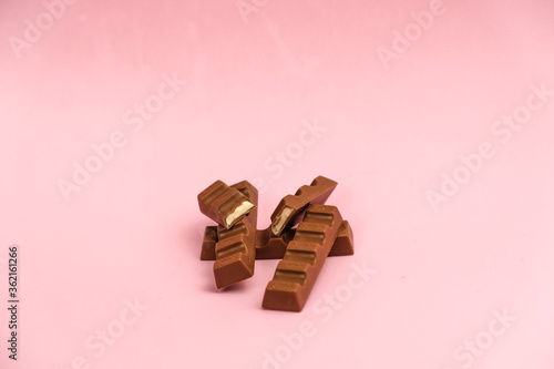 
milk chocolate with a filling on a pink background