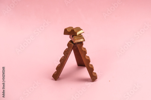 
milk chocolate with a filling on a pink background