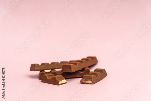
milk chocolate with a filling on a pink background