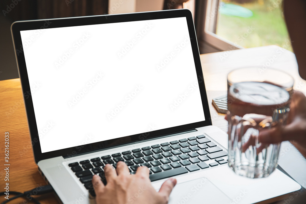 Isolation with clipping path. Young businessman working in front of the laptop computer during the quarantine or self-isolation. Businessman using notebook computer to work. Empty notebook screen. Isolation with clipping path. Young businessman working in front of the laptop computer during the quarantine or self-isolation. Businessman using notebook computer to work. Empty notebook screen.