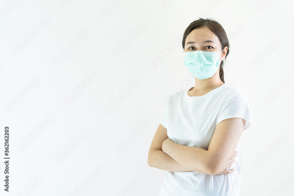 Asian young attractive woman wearing a protective hygiene mask over her face to protect flu and virus. Unwell influenza in infected woman portrait with yellow background. Covid19 and Coronavirus. Asian young attractive woman wearing a protective hygiene mask over her face to protect flu and virus. Unwell influenza in infected woman portrait with yellow background. Covid19 and Coronavirus.