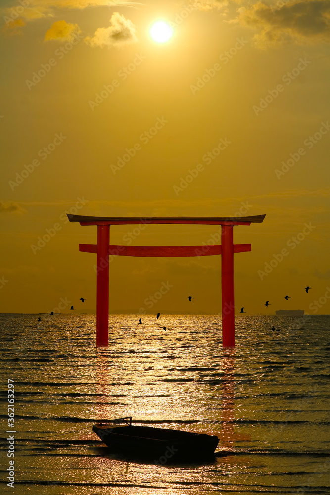 reflection torii sunset orange cloud on the sky and birds flying on the sea vertical view