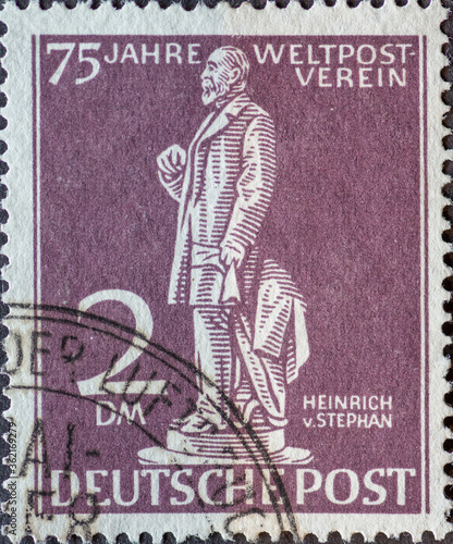 GERMANY, Berlin - CIRCA 1949: a postage stamp from Germany, Berlin in purple color showing the Postmaster Heinrich von Stephan Text: 75 years of world post association