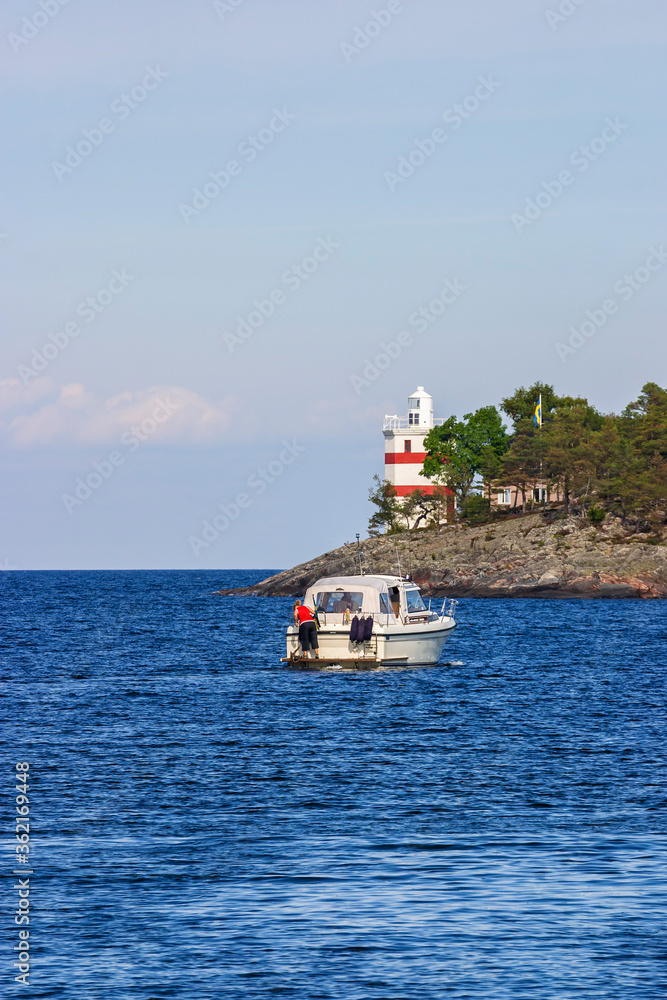 Motorboat by Luro lighthouse in lake Vanern, Sweden