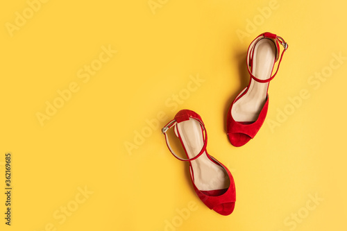 Trendy fashion red female shoes on yellow background. Flat lay, top view