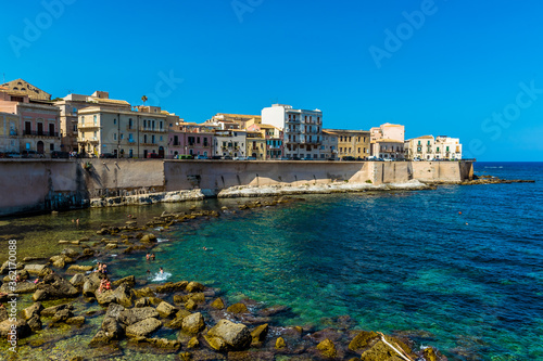 A view along the shoreline and embankment of Ortygia island in Syracuse, Sicily in summer