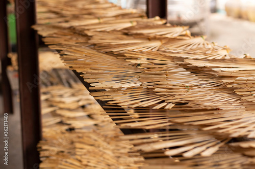 wooden frames of  hand fan arranged on the shelve